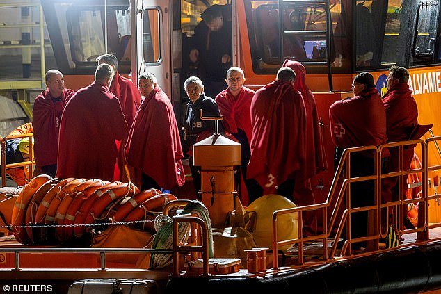 Survivors of the sinking of the Russian cargo ship Ursa Major stand on the deck of a Spanish maritime rescue ship upon arrival at the port of Cartagena, Spain, December 23, 2024