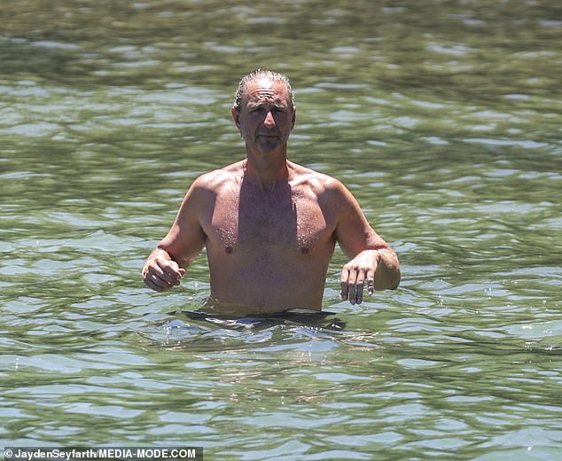 The Merivale boss was seen cooling off with a dip in the sea as he made the most of the balmy temperatures