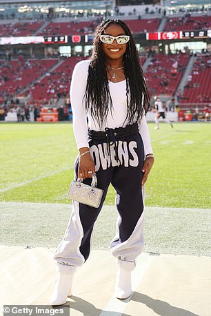 Biles is pictured on the sidelines of a Chicago Bears game cheering on her husband