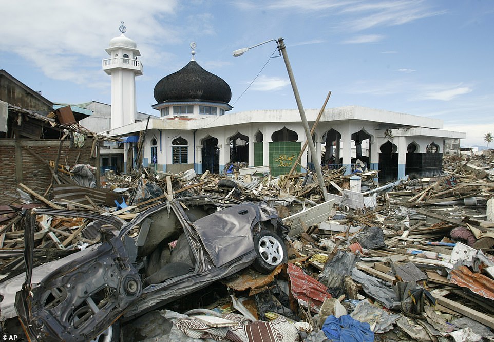 Debris scattered around a standing mosque in Banda Aceh, the capital of Aceh province, Tuesday, January 11, 2005, more than two weeks after a devastating tsunami ravaged Asia