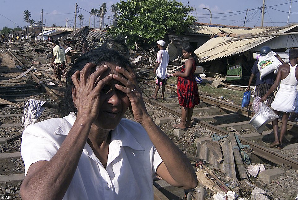 An unidentified woman cries after tidal waves destroyed her coastal home in Colombo, Sri Lanka, December 26, 2004