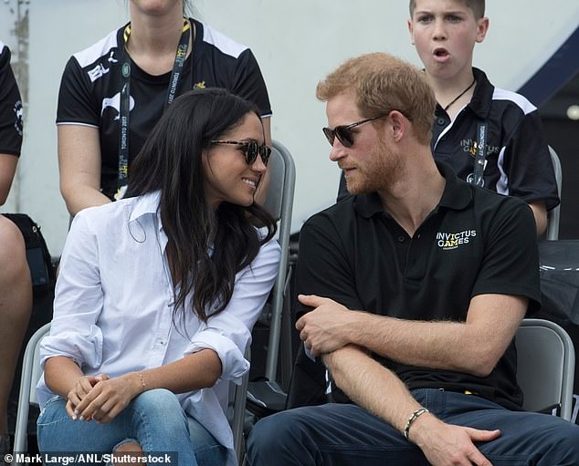 Meghan leans in as Harry speaks at the 2017 event in Toronto