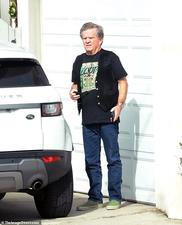 Patrick wore a classic pair of Ray-Bans, dark jeans, a black leather vest to complete the outfit and what appears to be a pair of green Slip-On Vans