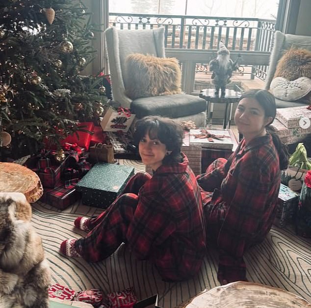 Emme was in her pajamas as she sat next to the Christmas tree with cousin Lucie