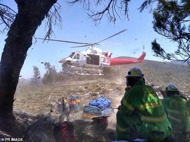 A helicopter is seen heading to battle the fires in the Grampians National Park