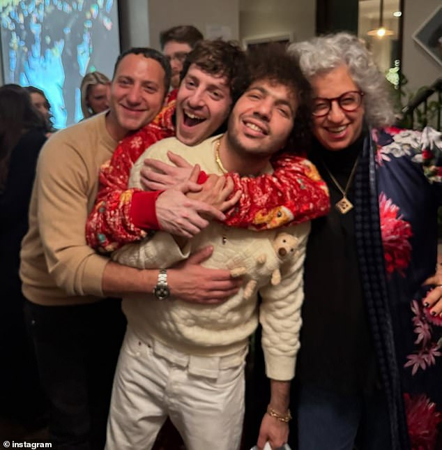 Benny wore a cream-colored sweater and matching beige pants