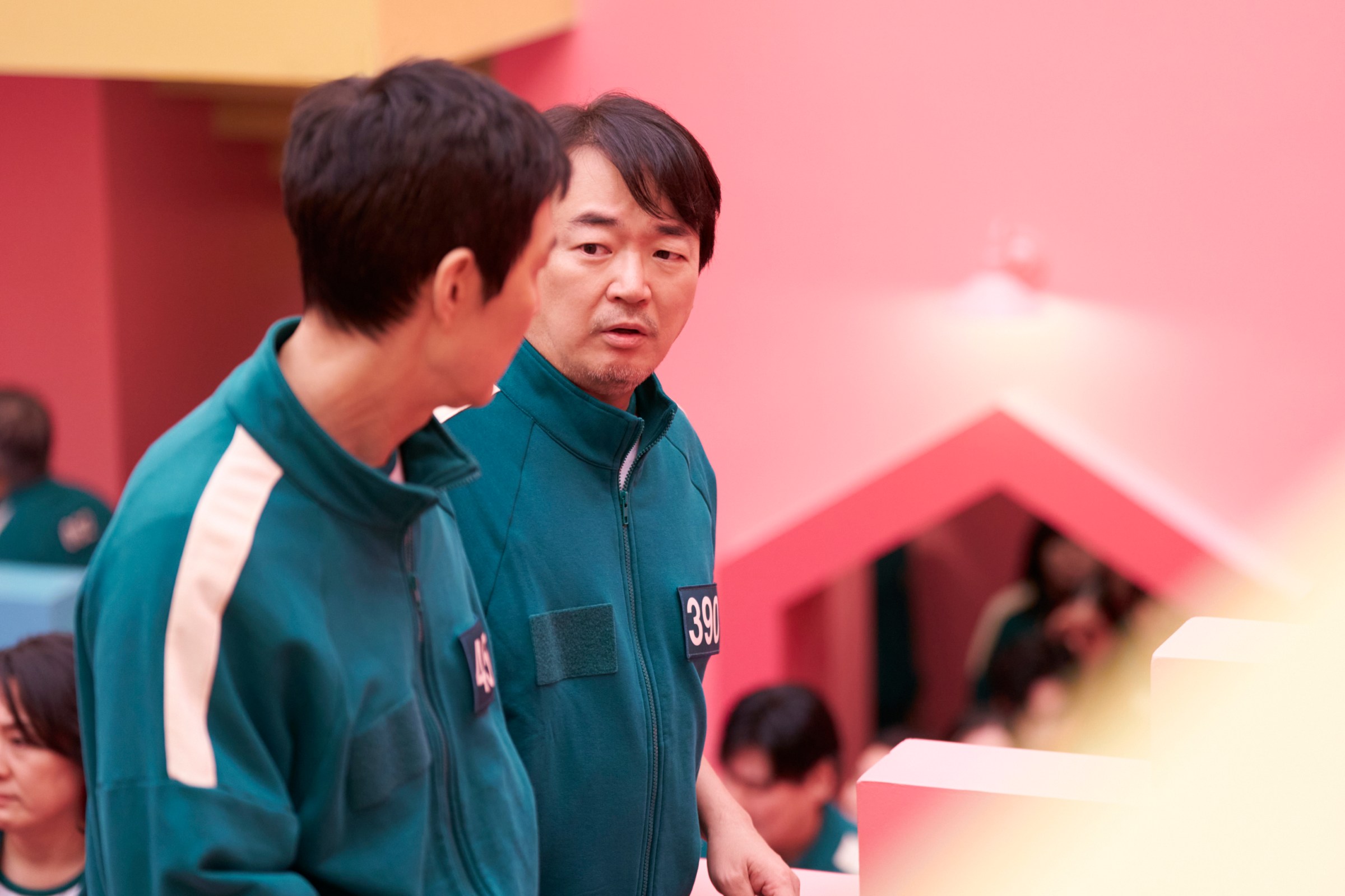 Jung-bae (Lee Seo-hwan) talks to Gi-hun in a still from Squid Game season 2