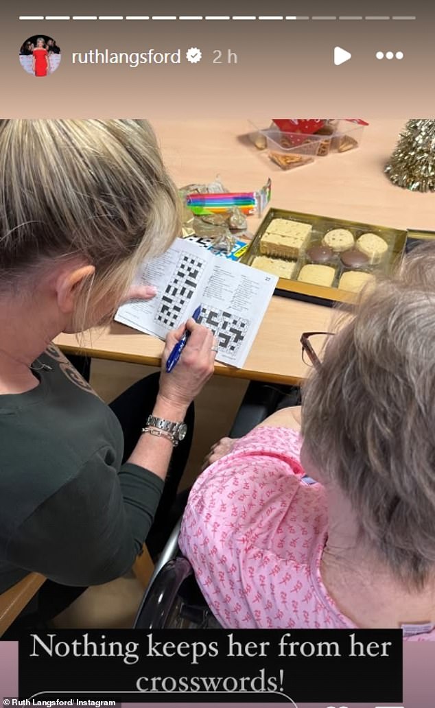 In another photo, the Loose Women star was seen with her blonde locks in a neat ponytail and dressed in a khaki top as she did a crossword with Joan.