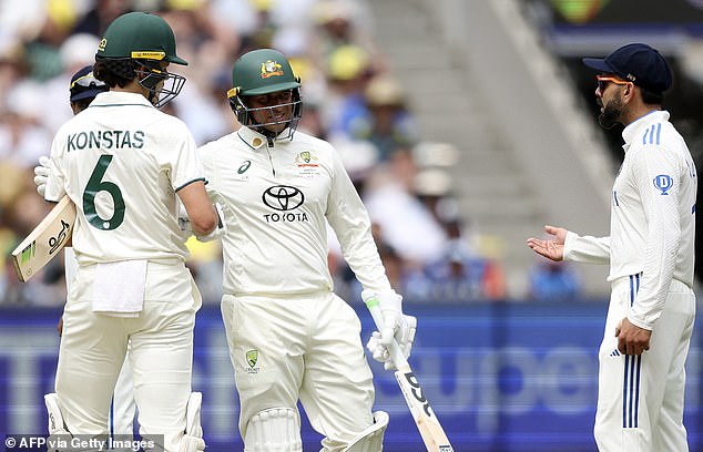 Kohli, 36, slammed his right shoulder into the debutant between overs, with Konstas exchanging some angry words with the veteran before Usman Khawaja calmed the situation at the crease (pictured)