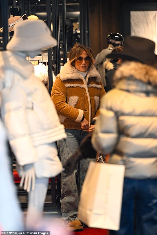 Lopez went into a winter clothing boutique to try on a brown coat with a sheepskin collar