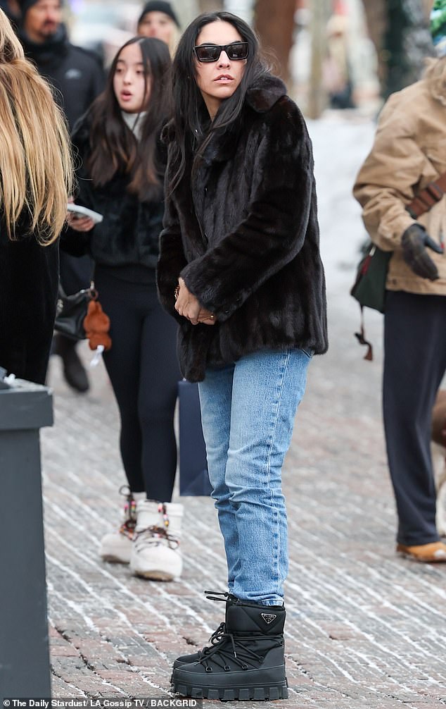 Alfallah wore a fluffy black coat, classic denim blue jeans and Prada boots to keep her warm in the winter weather