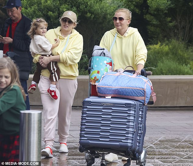 The couple's angelic daughter was seen smiling happily as she happily snuggled close to mom