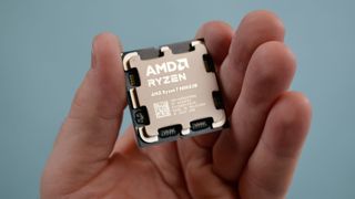 An AMD Ryzen 7 9800X3D in a male hand