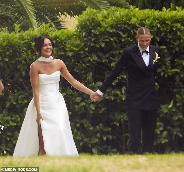 The pair beamed from ear to ear as they were linked in a ceremony at a vineyard in New South Wales' Hunter Valley.