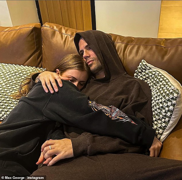 The musician wore a brown hoodie and matching sweatpants as Maisie rested her head on his chest