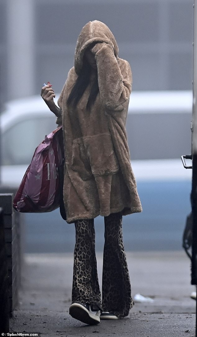 Katie opted for comfort as she arrived at Northwich's Memorial Court in a fluffy brown oversized blanket hoodie, teamed with the animal print wide leg