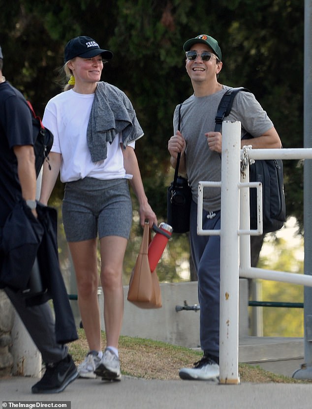 Kate, 41, looks casual in gray spandex shorts, with a loose T-shirt and a baseball cap