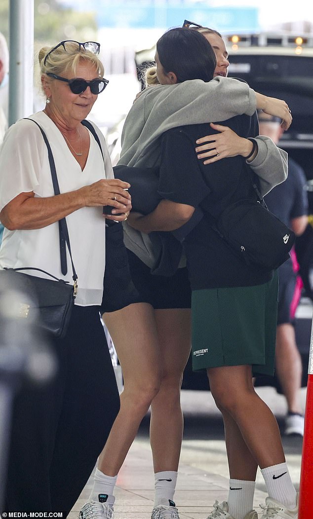 Kerr is comforted by fiancée Kristie Mewis before flying to Western Australia