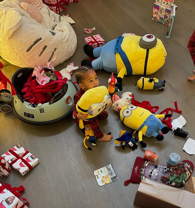 Taking to Instagram, The Kardashians star, 27, posted a photo of Aire cuddled with a Minion plush while surrounded by opened presents and toys