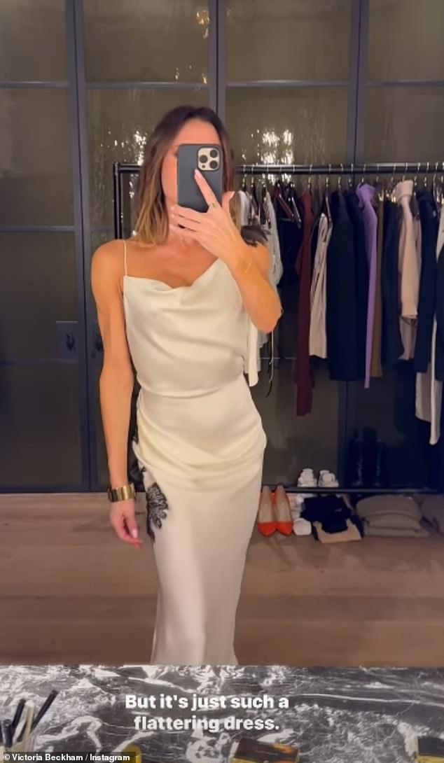 The fashion designer, 50, wowed as she modeled a flowing white satin dress for the camera while choosing an outfit for New Year's Eve