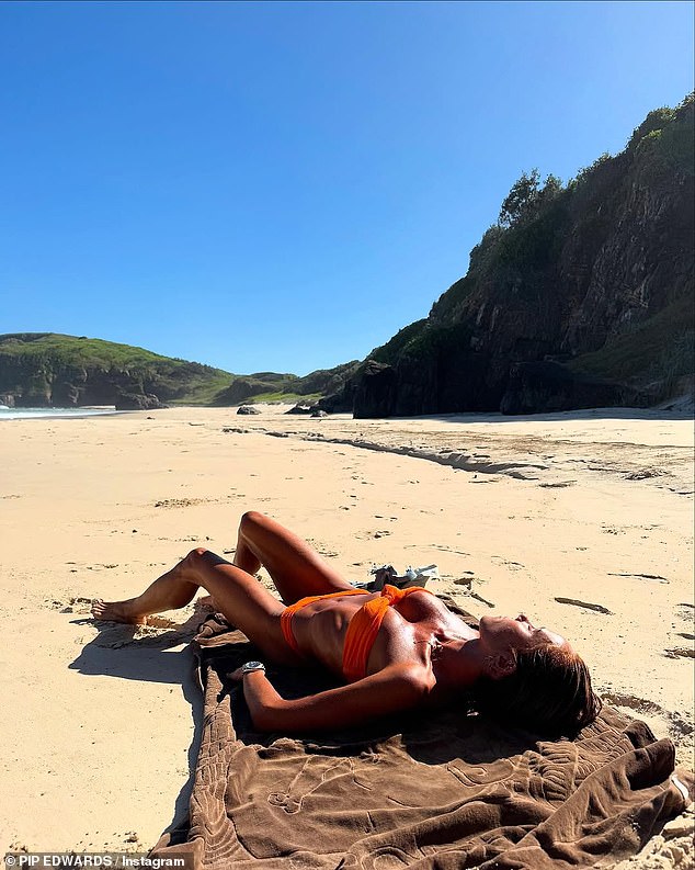 In photos shared to Instagram, Pip beamed as she stripped down from her jeans into an orange bikini. She then stretched out on a towel on the deserted beach