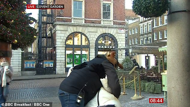 Carol was presenting the weather report in London when what appeared to be a passerby came up to the camera, wearing a coat and Santa hat, and pulled the star in for a hug.