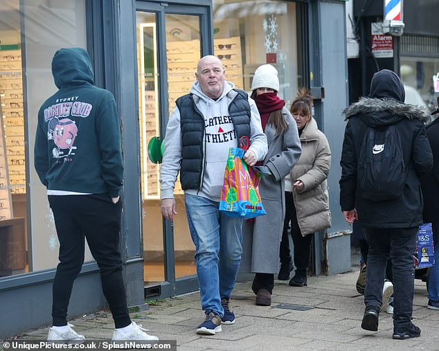 Meanwhile, Michelle's stepfather opted for a gray hoodie, black vest and blue jeans, while her mother donned a long tan padded coat.