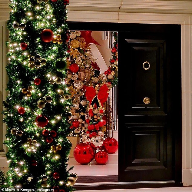 The actress also shared a glimpse of her entrance, where a large green and red arch framed her doorway, while inside, a huge red and gold Christmas tree stood at the bottom of the stairs.