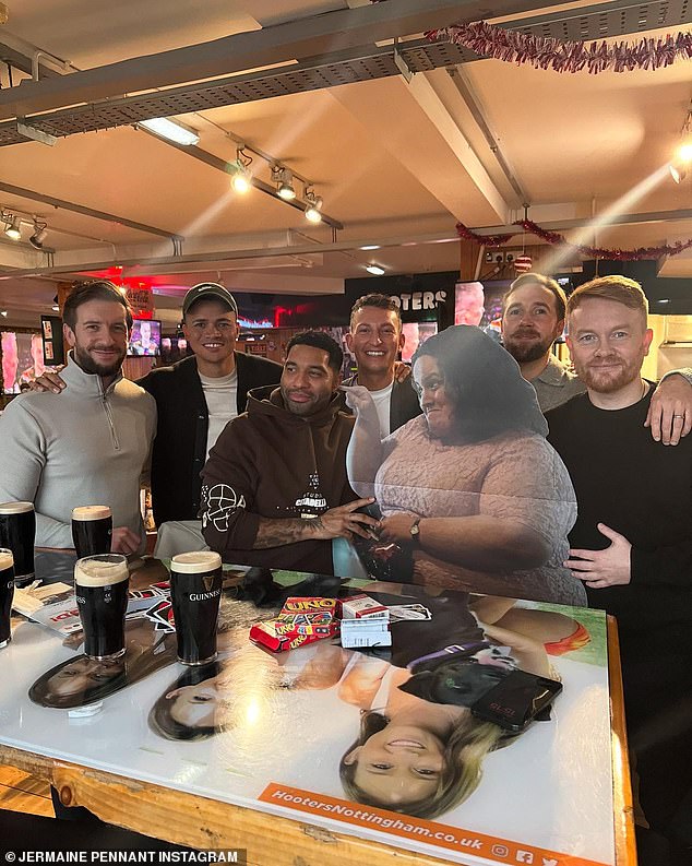 The two former footballers posed with the cutout as they sat around a table drinking Guinness and playing a game of Uno