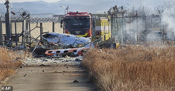 Fire trucks work to extinguish a fire at Muan International Airport in Muan, South Korea, Sunday, Dec. 29, 2024. (Maeng Dae-hwan/Newsis via AP)