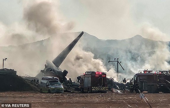 Firefighters conduct firefighting operations on a runaway plane at Muan International Airport in Muan, South Jeolla Province, South Korea, on December 29, 2024. Yonhap via REUTERS THIS IMAGE IS PROVIDED BY A THIRD PARTY. NO RESALE. NO ARCHIVES. SOUTH KOREA OUT. NO COMMERCIAL OR EDITORIAL SALES IN SOUTH KOREA.