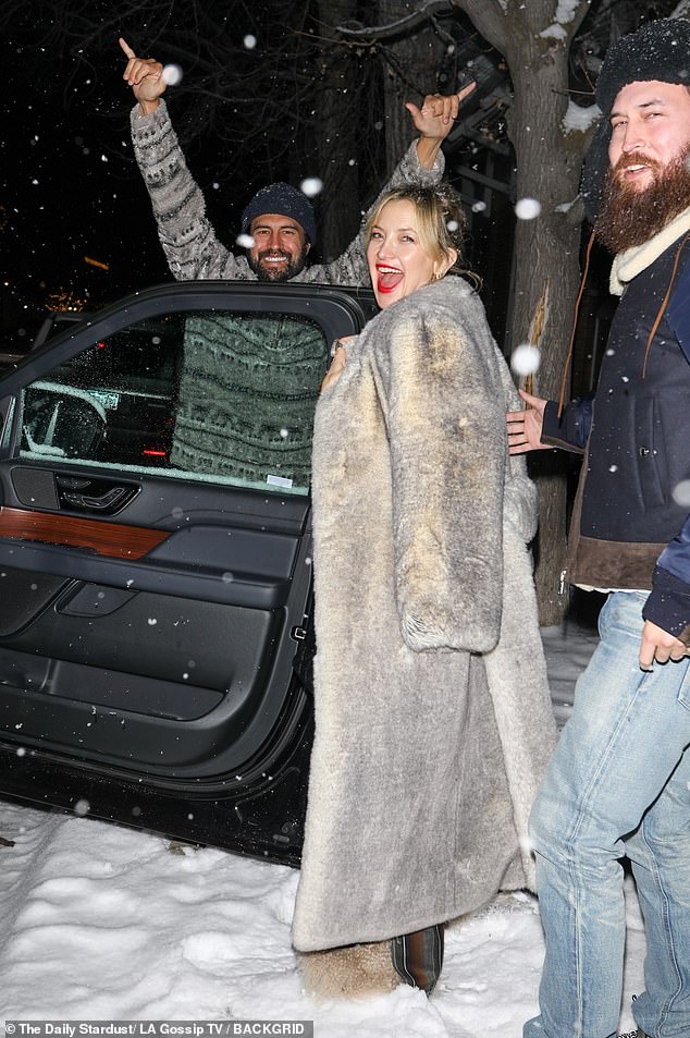 The 45-year-old actress was spotted bundling up to beat the 31-degree weather as she laughed alongside her partner Danny Fujikawa and her brother Oliver Hudson and other family members