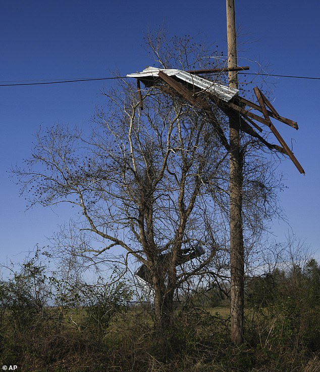 Debris remains clinging to power lines after a tornado ripped through Katy, Texas, on Saturday