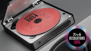 The FiiO DM13 CD player sits open on a speaker