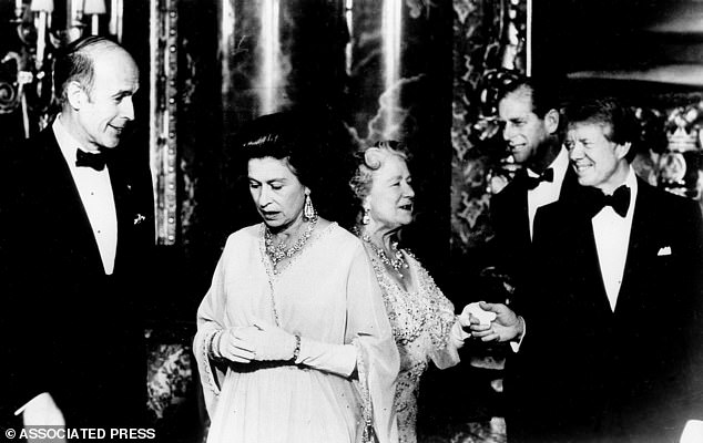 French President Giscard d'Estaing, left, talks with Queen Elizabeth II, and President Jimmy Carter accompanies the Queen Mother to pose for photographers ahead of the state dinner at Buckingham Palace on May 7, 1977. Behind Carter is Prince Philip