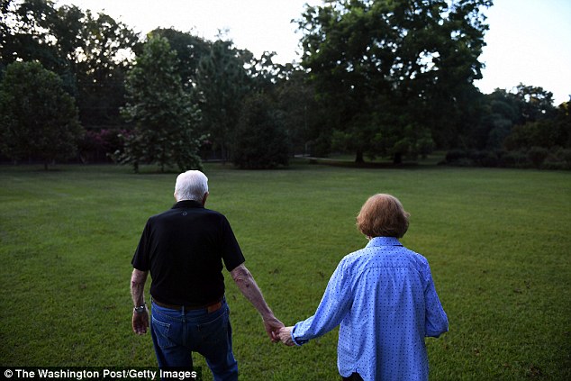 Carter walks with his wife, former First Lady, Rosalynn Carter to their home after dinner at a friend's house on Saturday, August 4, 2018 in Plains, GA