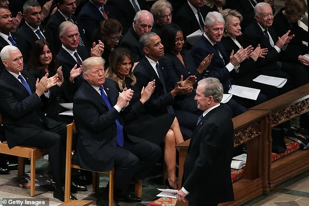 The four other living presidents are younger than Biden, including former President Donald Trump (front row, left), George W. Bush (right, standing), Barack Obama (third from left) and Bill Clinton (third from right)