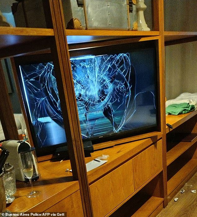 Photo released by Buenos Aires police showing a TV with a broken screen and a half-full glass of champagne in the hotel room