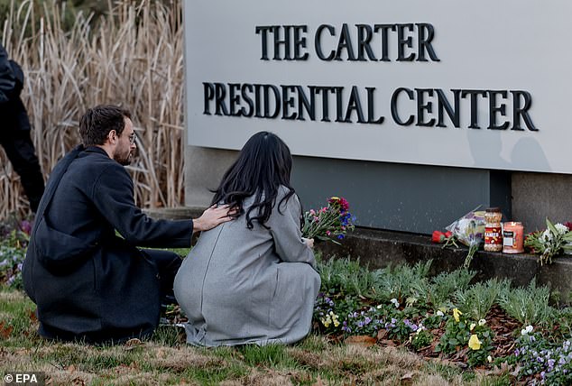 Mourners leave flowers at the Carter Memorial Center in Atlanta