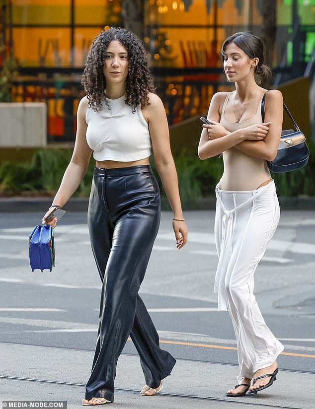 She completed her look with a white maxi skirt with a tie front and black kitten heels