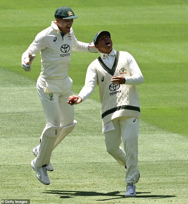 Usman Khawaja (front) and Alex Carey (back) celebrate Virat Kohli's dismissal