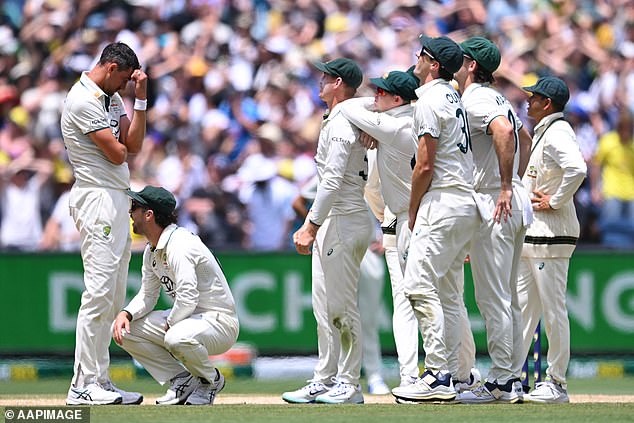 Pictured: Starc (left) and his teammates are shocked as Jaiswal is allowed to stay at the crease during India's thrilling chase