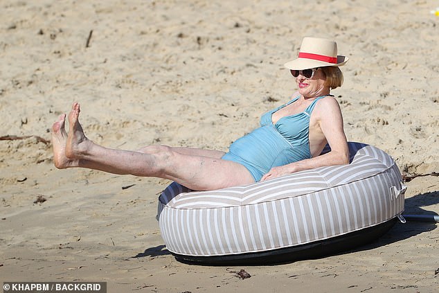 Gai was eager to pull up her heels as she worked on her tan while leaning back on a large bouncy castle