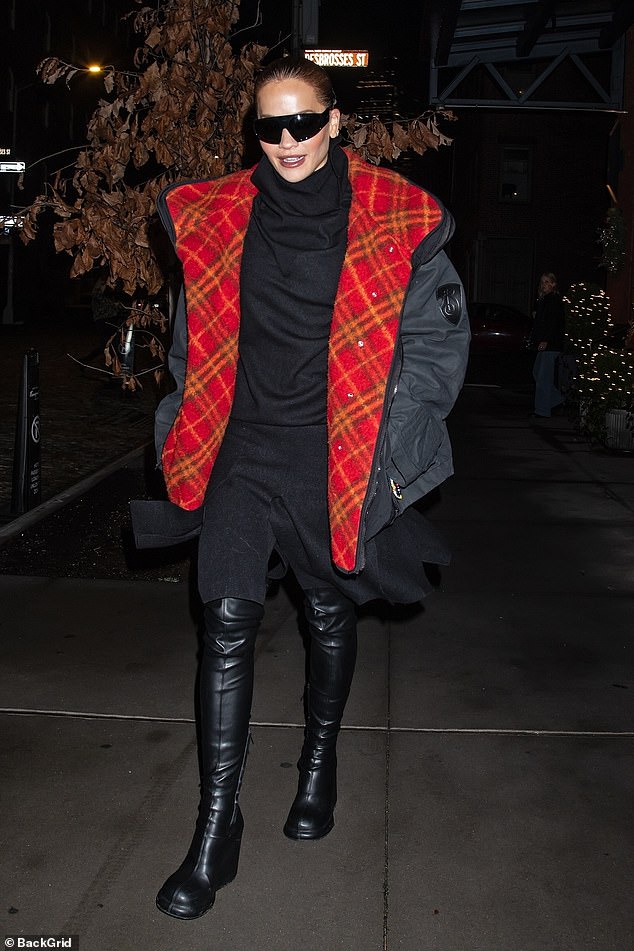 The 34-year-old singer was spotted in a statement black puffer coat with a red plaid lining as she headed to Times Square, where she will co-host Dick Clark's New Year's Rockin Eve with Ryan Seacrest.