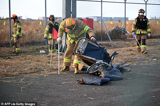 Recovery teams work at the site where a Jeju Air Boeing 737-800 series aircraft crashed and caught fire at Muan International Airport in Muan on December 30, 2024