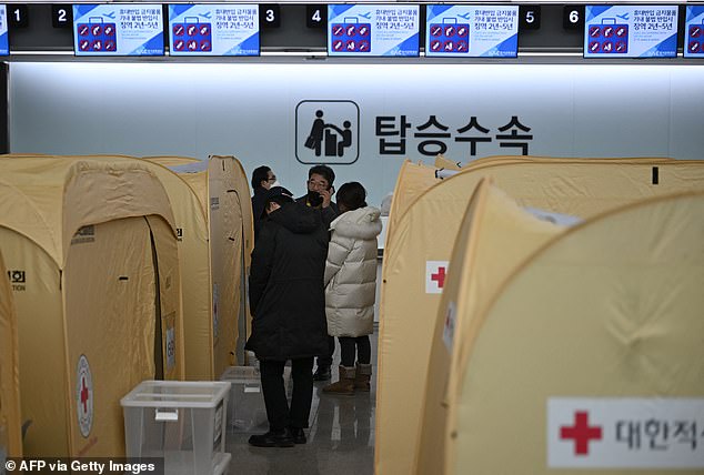 Relatives of passengers of a Jeju Air Boeing 737-800 series aircraft gather in a makeshift shelter at Muan International Airport in Muan