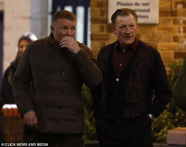 Guy is seen with an actor on set as they film scenes in the boxing gym