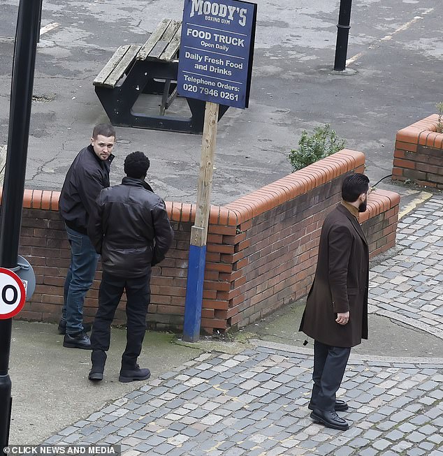 Actors in the gangster drama hover outside the boxing gym as cast scenes are filmed