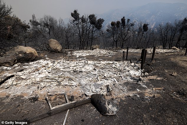 Pictured: The ruins of a burned structure are seen the day after the bridge fire exploded in size from 2,995 hectares to 46,727 hectares in a single day in September 2024