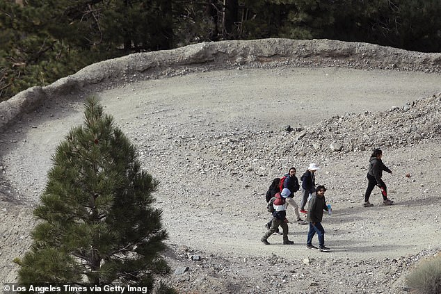 Pictured: Hikers climb a trail leading to Mount Baldy Ski Resort on December 14, 2024